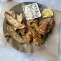 Crispy Wild Caught fish and chips featuring Alaskan Ling Cod, hook and line caught with potatoes, lemon and tartar sauce