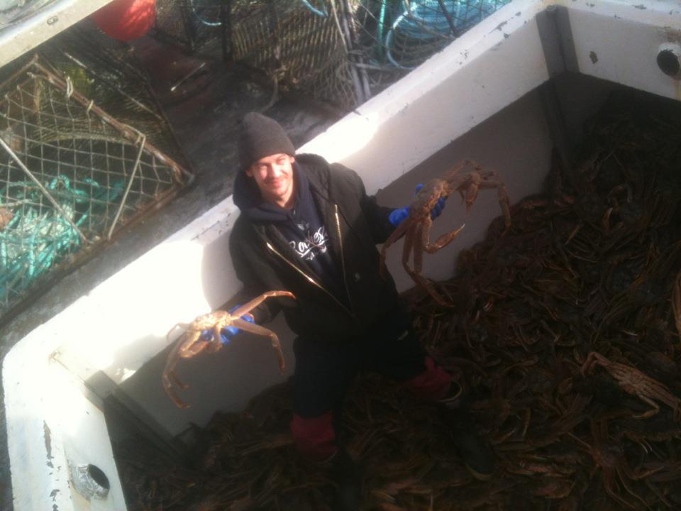 Ryan Horwath Holding Kodiak Island Tanner crab in fish hold